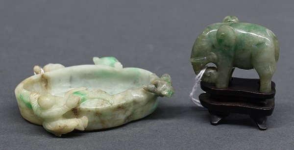 Chinese Jadeite Brush Coupe/Elephant: (lot of 2) Chinese jadeite brush washer, of lobed melon form with a child catching ducks perched on the rim (chips), 3.3"w; together with an elephant, executed from a mottled green matrix, with wood s