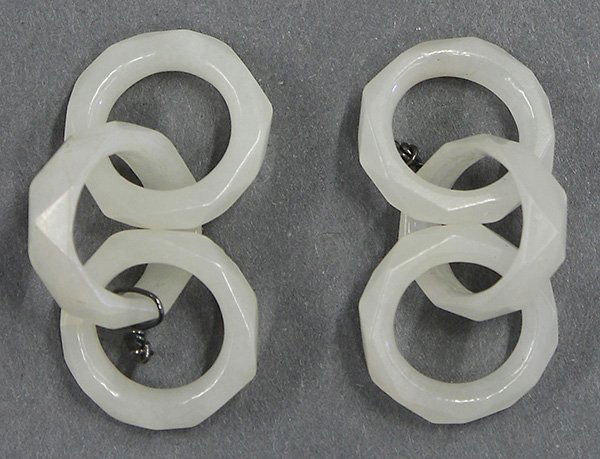 Chinese Chains of Jade Rings: (lot of 2) Sets of Chinese jade linked rings, each carved with three faceted jade rings, executed from a celadon-white matrix, 1.5"w