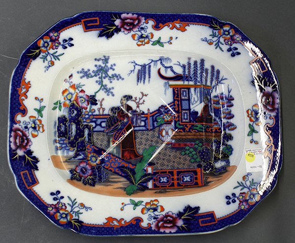 Polychrome chinoiserie ironstone meat platter: Polychrome Chinoiserie decorated ironstone well and tree meat platter, 19th century, having a shaped rim accented with a cobalt band and pink peonies, centering a scene of a pagoda and a beauty under 