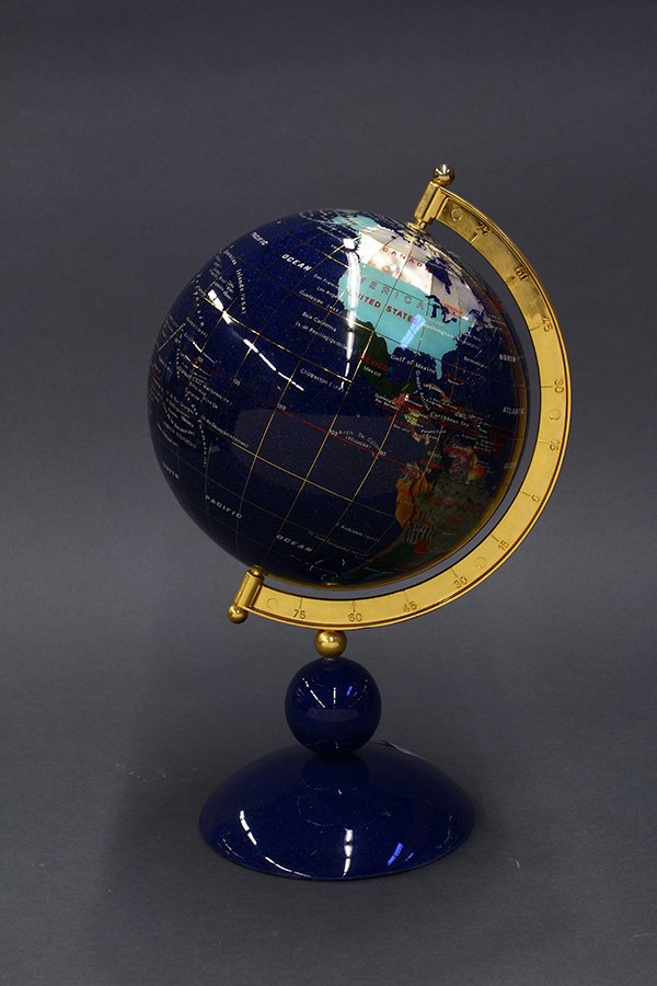 Globe on stand executed in inlaid semi precious stones,: Globe on stand executed in inlaid semi precious stones with brass accents, rising on a circular base, 16"h