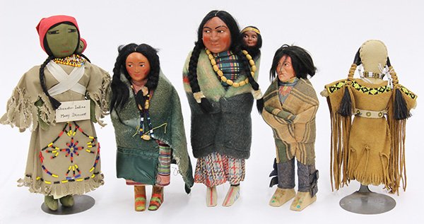 Native American Skookam and Cherookee dolls: (lot of 5) Native American dolls, consisting of three Skookam dolls having hand decorated celluloid faces, and dressed in original traditional attire; together with two Cherokee dolls, one of hide and