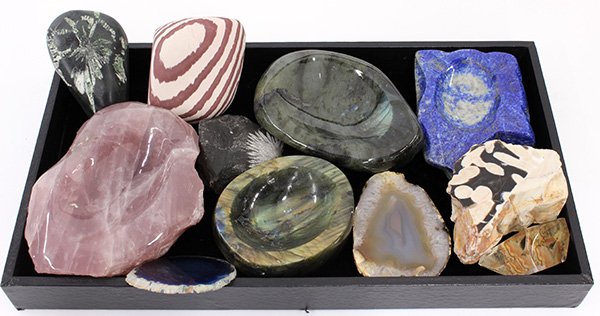 One tray of mineral specimens,: (lot of 11) One tray of mineral specimens, including (2) labrodorite bowls, a rose quartz bowl, a sodalite bowl, a plant fossil in black stone, and (2) geode slices (one dyed), largest 2"h x 5.5"l. Pr