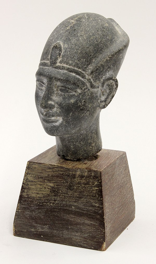 Ancient Egyptian style carved grey granite bust of a: Ancient Egyptian style carved grey granite bust of a pharoah, gazing outward with an expression of contentment, above a wood base, 11.5"h overall. Provenance: Unaccessioned items from The Honolulu Mus