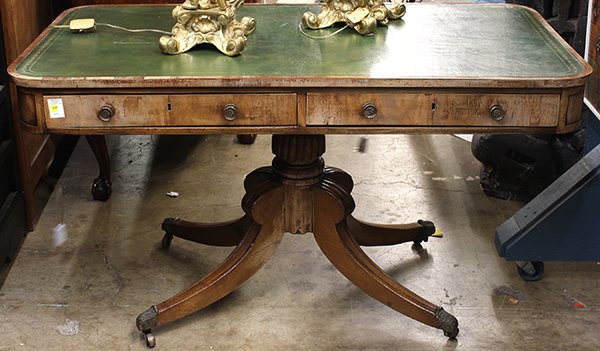 Partners desk: Regency library desk, 19th century, having an embossed leather writing surface, above the two drawer case, rising on a reeded cup and cover standard terminating on splayed legs ending on brass capped 