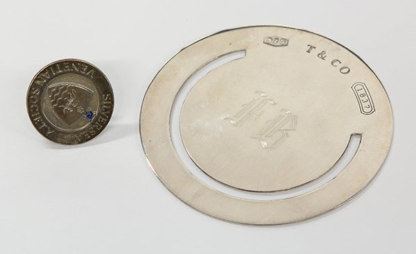 Tiffany book mark and tie tac: (Lot of 2) Tiffany & Co. sterling silver items including one monogrammed book mark, stamped 1999 Tiffany & Co. 925, together with a sapphire and sterling silver Sea Venetian society tie tac, stamped T