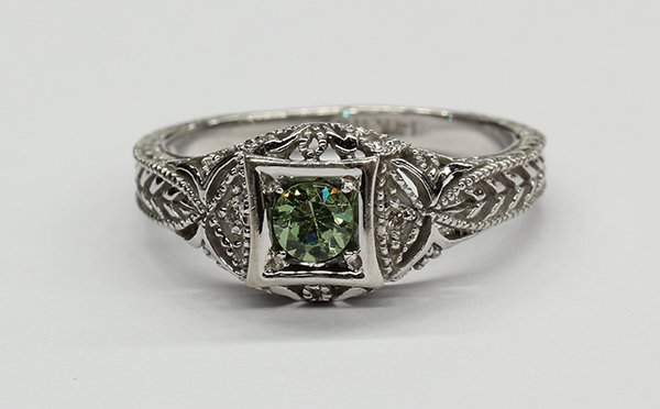 Demantoid garnet diamond white gold ring: Demantoid garnet, diamond and 14k white gold ring featuring a round cut demantoid garnet weighing approximately 0.40 ct., accented by (6) full cut diamonds totaling approximately 0.06 ct., set in an e