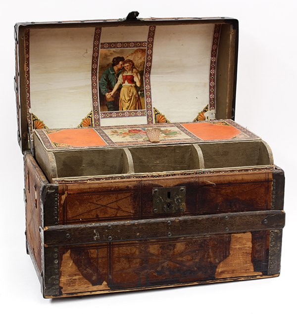 Victorian trunk and quilt: (lot of 2) Victorian leather, oak, and wrought iron trunk, having a tiered interior, the top case accented with period paper, lifting out to reveal the open interior housing a Victorian patchwork quil