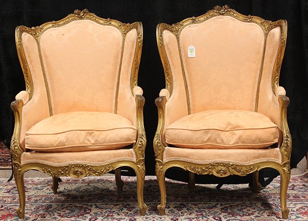 Pair of Louis XV style giltwood carved bergeres: Pair of Louis XV style giltwood carved bergeres, each having a wing back, accented with a relief carved crest continuing to the acanthus decorated returns, and rising on cabriole legs, 42"h x 28"w x 2