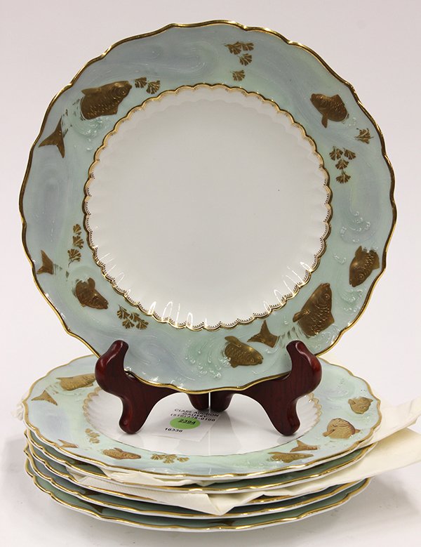 (lot of 6) Mintons fish plates: (lot of 6) Mintons fish plates, each having a partial gilt border depicting frolicking fish in a sea foam current, flanking the scallop decorated center on a white ground, verso with Minton mark and N