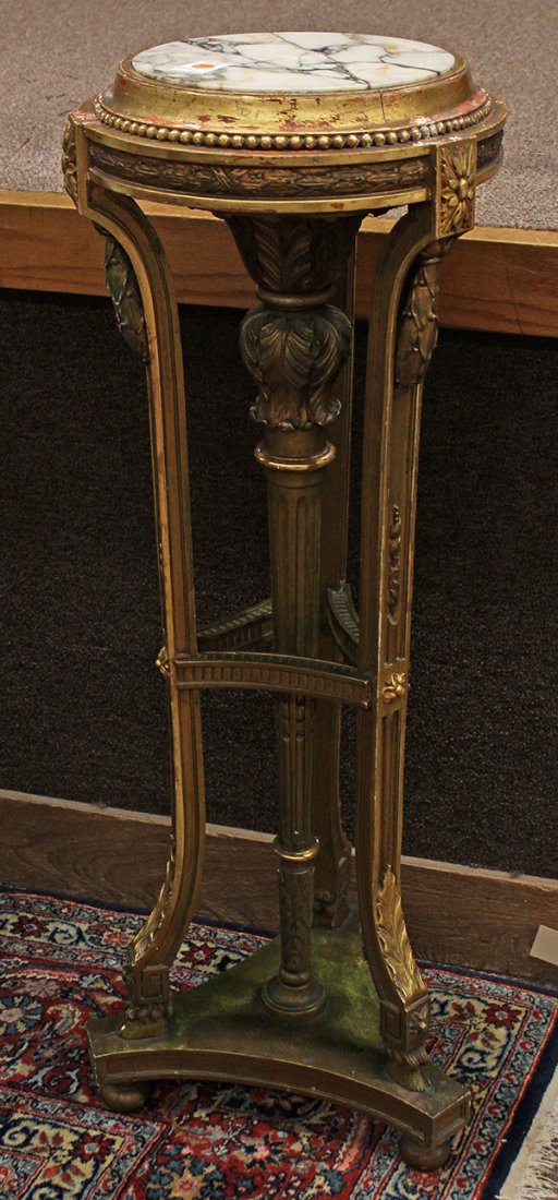 Neoclassical style pedestal: Neoclassical style pedestal, the circular variegated marble top above the gilt base supported by a columnar standard centering the tripod supports terminating on hoof feet, and rising on spherical fee