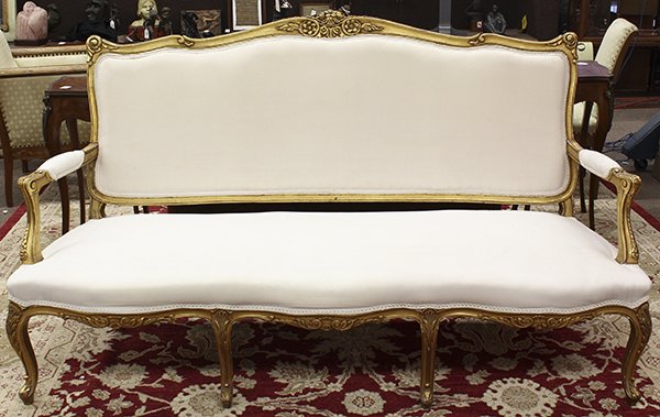 Rococo style giltwood carved settee: Rococo style giltwood carved settee, having a shaped crest with a floral medallion, the outswept arms with acanthus returns, and rising on cabriole legs, 42"h x 74"w x 26"d
