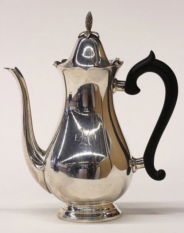 Cartier sterling silver coffee pot, 17.28 troy oz.: Cartier sterling silver coffee pot, the elegant form with an ebony scroll loop handle, and raised on a circular base, 9.25"h, 17.28 troy oz.