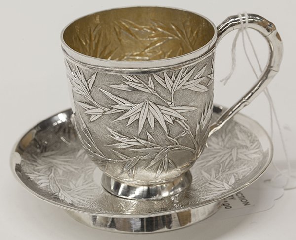 (lot of 2) Chinese Export silver teacup and saucer, by: (lot of 2) Chinese Export silver teacup and saucer, by Wang Hing & Co., Hong Kong, late 19th century, the cup having a repoussé bamboo motif over a hammered ground, the saucer having a matching incis