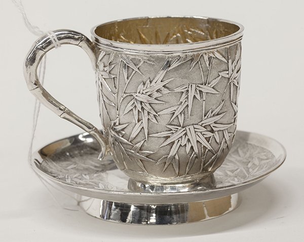 Chinese Export silver teacup and saucer, by Wang Hing &: (lot of 2) Chinese Export silver teacup and saucer, by Wang Hing & Co., Hong Kong, late 19th century, the cup having a repoussé bamboo motif over a hammered ground, the saucer having a matching incis