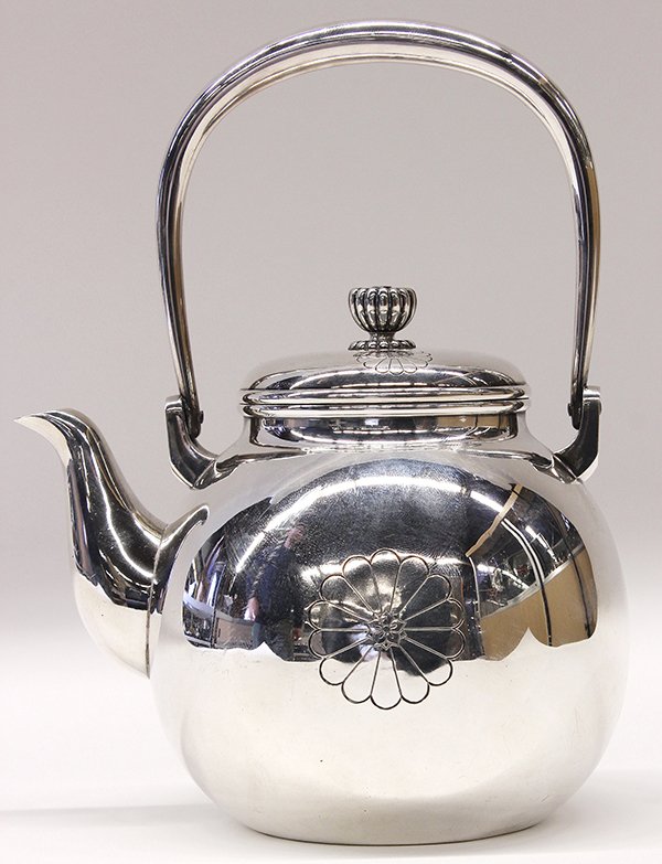 Japanese Silver Tea Kettle: Japanese silver tea kettle, decorated with chrysanthemums on the body and chrysanthemum shaped finial, marked in Japanese "pure silver" and the maker "Tenshodo" of Tokyo, 12.3 troy oz.