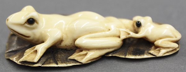 Japanese Ivory Netsuke Frog Mother and Baby: Japanese ivory netsuke, Meiji period, mother and baby frog on lotus leaves, signature underneath, 2.5"l; Provenance: Unaccessioned items from The Honolulu Museum of Art
