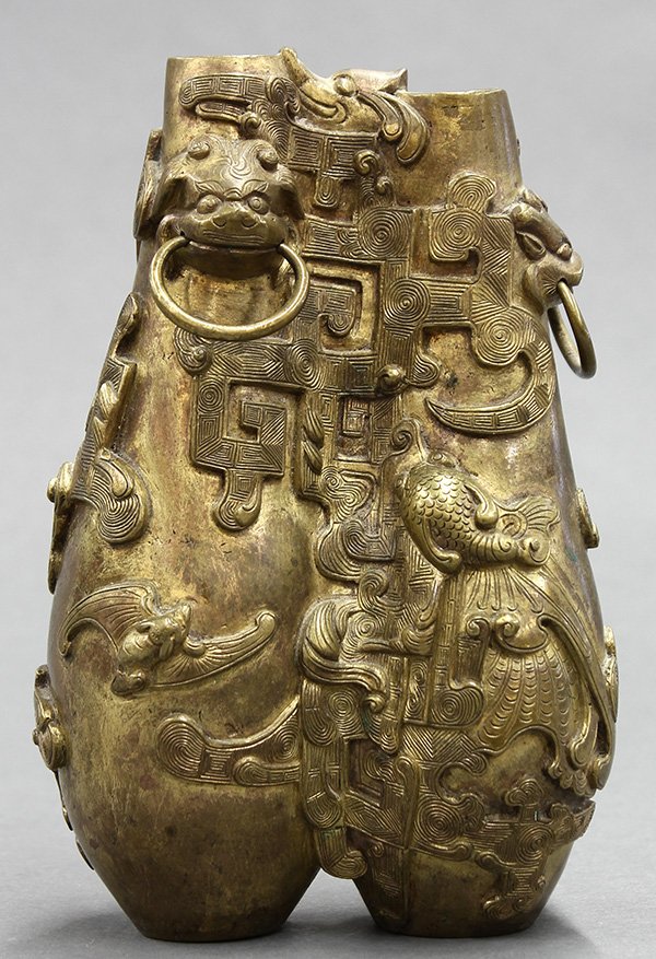 Chinese Metal Double Vase, Dragons: Chinese gilt metal double vase, with a conjoined body cast with archaistic dragons and bat, the neck with zoomorphic handles suspending loose rings, the base with an apocryphal Qianlong mark, 6.25"h