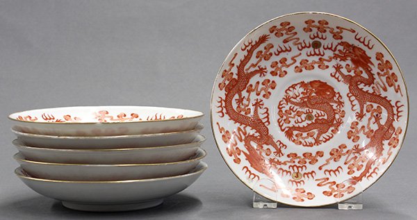 Chinese Porcelain Dishes, Red Dragons: (lot of 6) Chinese gilt and iron red porcelain plates, each centered with a dragon medallion surrounded by a pair of writhing dragons, the base with a Guangxu mark, 5.75"w; Provenance: Estate of Reyno