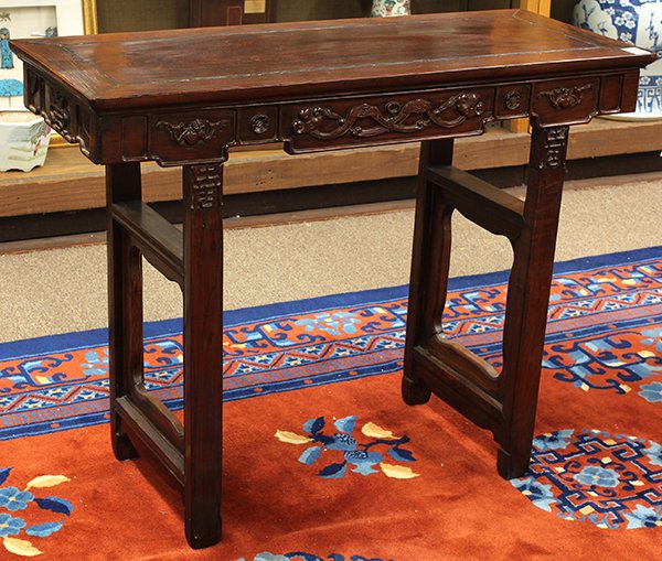 Chinese Small Side Table, Ruyi: Chinese wood side table, the rectangular top fronted by a shaped apron carved with a pair of ruyi and bats, raised on trestle supports, 31.25"h x 40"w x 16.5"d