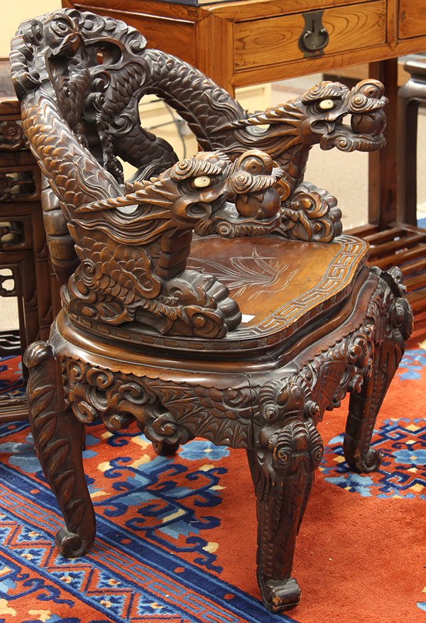 Japanese Export Dragon Chair: Japanese export wood armchair, late 19th/early 20th century, the back and arms formed by a pair of dragons, set above the shaped seat with a key-fret band and centered with an iris, raised on dragon-f