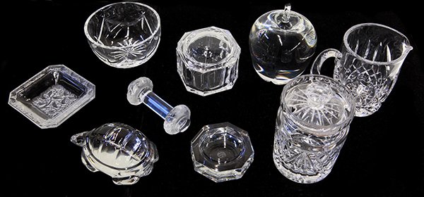 Lalique, Baccarat, Steuben, Tiffany, and Waterford: (lot of 9) Crystal table accessories including a Lalique knife rest, and pin tray executed in clear and frosted crystal having bas relief birds and trees, 3.5"sq; a Steuben apple, 4.5"h; Baccarat turt