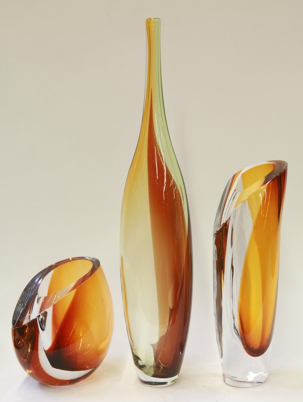 Swedish art glass by Goran Warff and Kgell Engman for: (lot of 3) Swedish art glass by Goran Warff and Kgell Engman for Kosta Boda, consisting of two modernist vases from Warff''s 'Amber' series that mix clear crystal in sinuous forms with a splash of amb