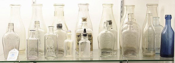 Antique and vintage glass bottles in clear and cobalt: (lot of 23) Antique and vintage glass bottles in clear and cobalt mostly by and for Oakland, Ca. companies, including a rare 'Ghirardelli Branch Oakland' soda bottle, as well as, other soda pop bottle