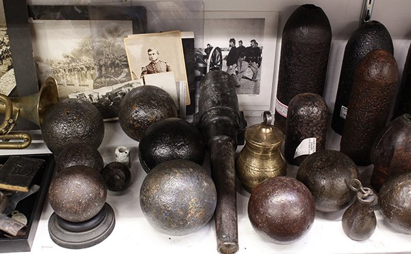 An archive related to the military: (lot of 39) An archive related to the military, including (5) photographs, an 1864 diary, a trumpet, a bayonette, an ammunition pouch, (10) cast iron cannon balls of varying sizes, (5) civil war shell