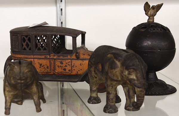 (lot of 4) Cast iron figural banks: (lot of 4) Cast iron figural banks, including the 'Eagle on Globe' bank by Enterprise, a seated pig by A. C. Williams, the 1906 Hubley elephant bank, and a taxi cab bank by Arcade (driver lacking), ta