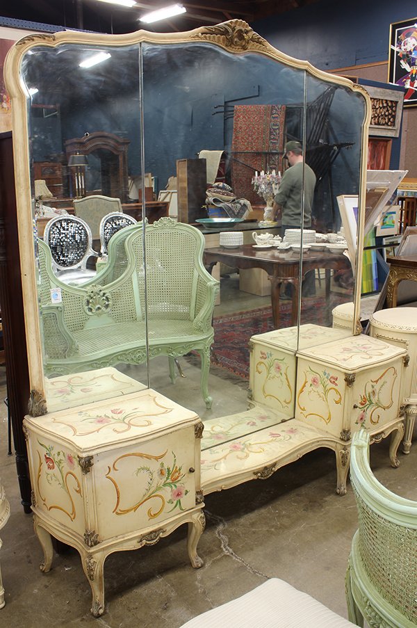 Continental style vanity: Continental style vanity, having a carved crest continuing to the three paneled mirror above the polychrome floral decorated case having two doors, each opening to reveal a single drawer, and rising o
