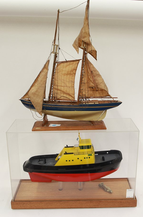 Associated ship models: (lot of 2) Associated ship models, consisting of a tug boat in an acrylic case with wood base, 14"h x 22"w x 8.5"d; together with a masted schooner resting on wooden base