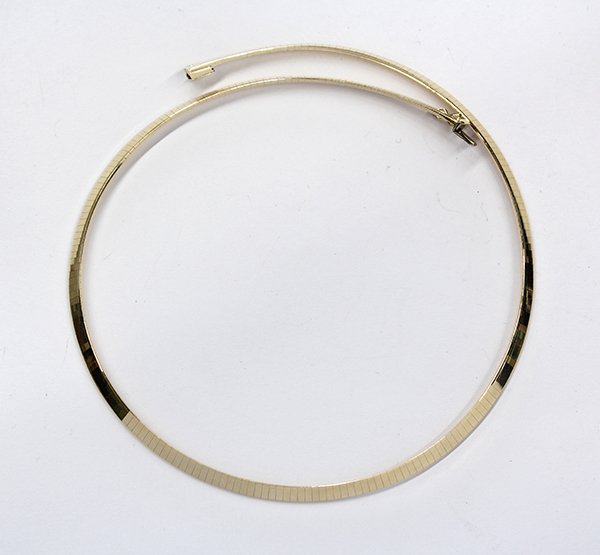 Yellow gold omega choker necklace: 14k yellow gold Omega choker necklace is 4mm in width and 17 1/2 inches in length, 27.3 grams. Stamped OM Italy