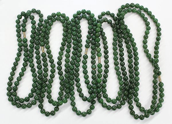 Collection of nephrite jewelry: Collection of nephrite jade and gold-plated jewelry including six bead necklaces (one broken); Four carved pendant necklaces; One cross and three bracelets