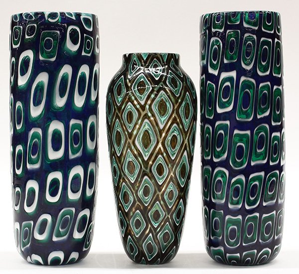 Art glass vases by Michael Nourot (American b.1949): (lot of 3) Art glass vases by Michael Nourot (American b.1949), circa 1980, two vases of cylindrical form having repeating geometric patterns executed in the Venetian murrini technique, in white and g