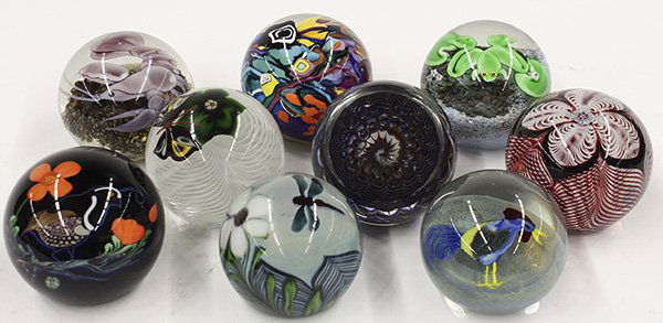 Art glass paperweights by Lundberg Studios: (lot of 9) Art glass paperweights by Lundberg Studios, Smyers Glass, and Lee Hudin, including (2) weights by Hudin with pulled feather lattice work and cane flowers, each captured in clear glass, sign