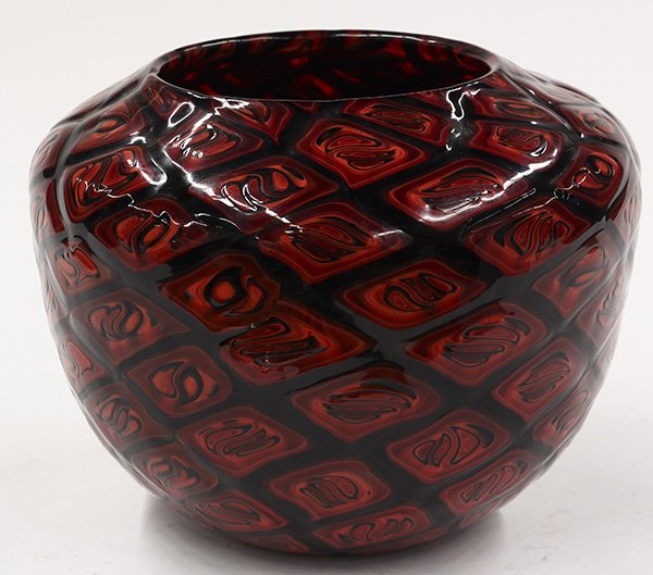 Art glass vase by Michael Nourot: Art glass vase by Michael Nourot (American b.1949), circa 1980, the large bulbous form having repeating geometric patterns executed in crimson, orange,and oxblood accented with black, using the Veneti