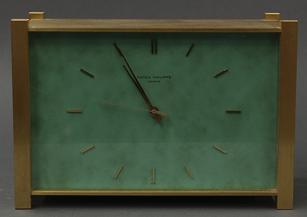 Patek Philippe electroquartz table clock: Patek Philippe electroquartz table clock model 1100/2, having stick chapters, and housed in a gilt metal and mottled celadon case, rising on square feet, (quartz movement, needs service) 5.75"h x 8.5"