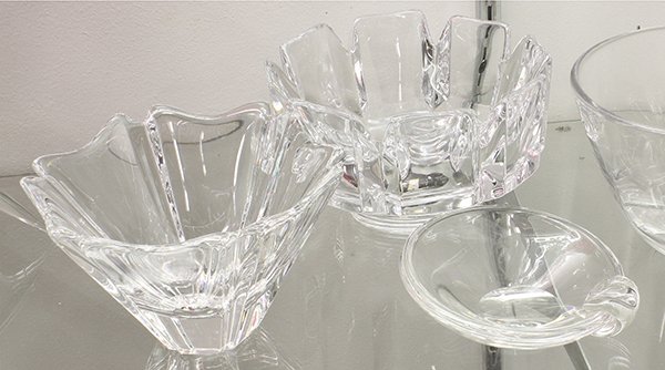 Crystal group: (lot of 3) Group of associated crystal bowls by Orrefors and Steuben, consisting of (2) clear low bowls by Orrefors and an ash receptacle by Steuben, largest 4,5"h x 7"dia