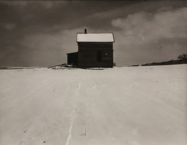 Photograph, Wright Morris, Farmhouse in Winter,: Wright Morris (American, 1910-1998), "Farmhouse in Winter, Nebraska (1941)," gelatin silver print, signed in pencil verso, later reprint, sheet: 11"h x 14"w, overall (with frame): 16.5"h x 20.5"w. Pro