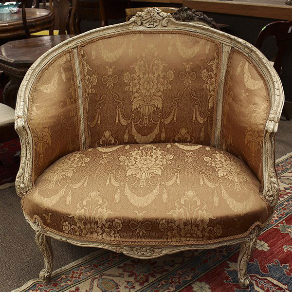 Louis XV style marquise: Louis XV style marquise, having a floral carved crest leading to continuous arms, the back and seat with peach upholstery centering the paint decorated frame rising on cabriole legs, 39"h x 41.5"w x 2