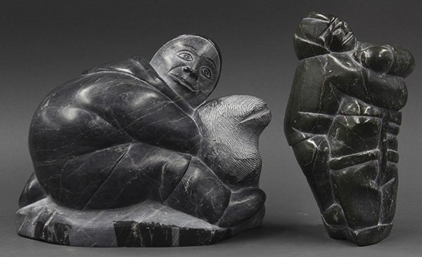 (lot of 2) Inuit soapstone carving group: (lot of 2) Inuit soapstone carving group, one depicting a hunter, his arms wrapped, base retains 'The Quest' label, and numbered E-( 1425, 9.5"h, one executed in grey stone depicting a crouched figure