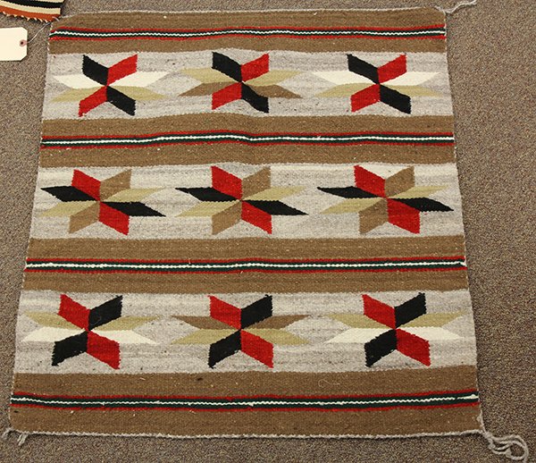 (lot of 2) Navajo weavings: (lot of 2) Navajo weavings consisting of a Chamayo saddle blanket 30" x 31", together with a mat centered with a whirling log medallion 17.5" x 19"