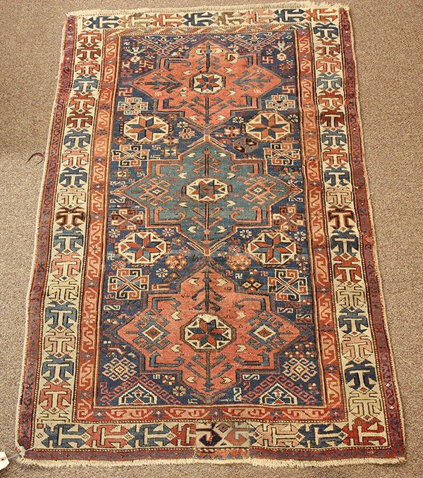 Caucasian rug: Caucasian rug, having repeating medallions on a blue ground, circa 1920, 5"h x 3'1"w. Provenance: The Jeff Sahadi collection