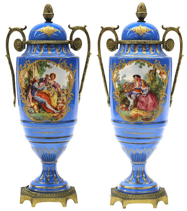 Pair of French Old Paris covered urns: Pair of French Old Paris covered urns, each with gilt acorn finials surmounting robin's egg blue bodies centering hand painted reserves depicting couples in pastoral settings, bodies taper to circular