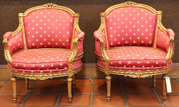 Pair of Louis XVI style giltwood bergeres: Pair of Louis XVI style giltwood bergeres, each with carved floral crests leading to gadrooned stiles, the back and seat upholstered in red with gold bees in the Napoleonic taste, having carved aprons