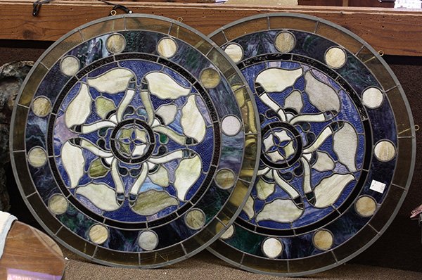 Victorian round stained glass windows: (lot of 2) Victorian round stained glass windows, having stylized floral center medallions in white cobalt and lavender, ringed with white dots on a blue ground, 35"dia. Provenance: The Jeff Sahadi co