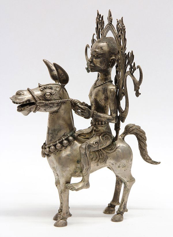 South East Asian silver plate figure of a diety: South East Asian silver plate figure of a diety depicted riding on a donkey, 16"h x 12"w x 4.5"d
