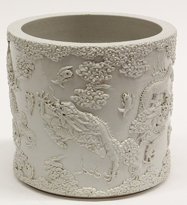 Chinese Porcelain Brush Pot, Dragons: Chinese white glazed porcelain brush pot, carved and applied with five writhing dragons amid fish leaping out of the sea, the base marked 'Wang Bingrong', 8"h