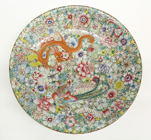 Chinese Mille Fleur Dragon/Phoenix Charger: Chinese famille rose porcelain charger, with a pair of dragons and phoenix meandering amid a mille fleur ground, the base with an apocryphal red Qianlong mark framing an underglaze blue pictorial mark