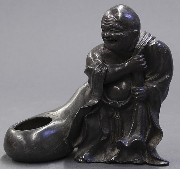 Chinese Pewter Budai Brush Washer: Chinese pewter figural brush washer, of Budai dragging a large sack with an opening forming the shallow well of the coupe, 5.3"w